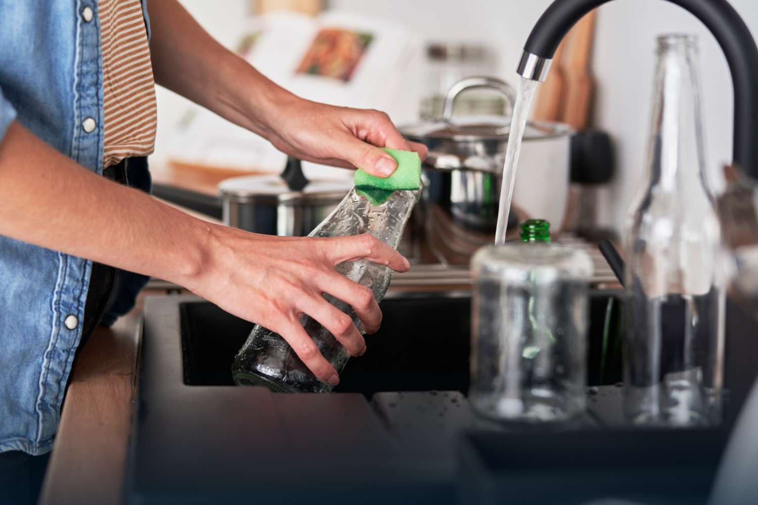 Everyday kitchen scene showing reusable cleaning bottles being washed, highlighting Truly Free’s commitment to sustainable home care