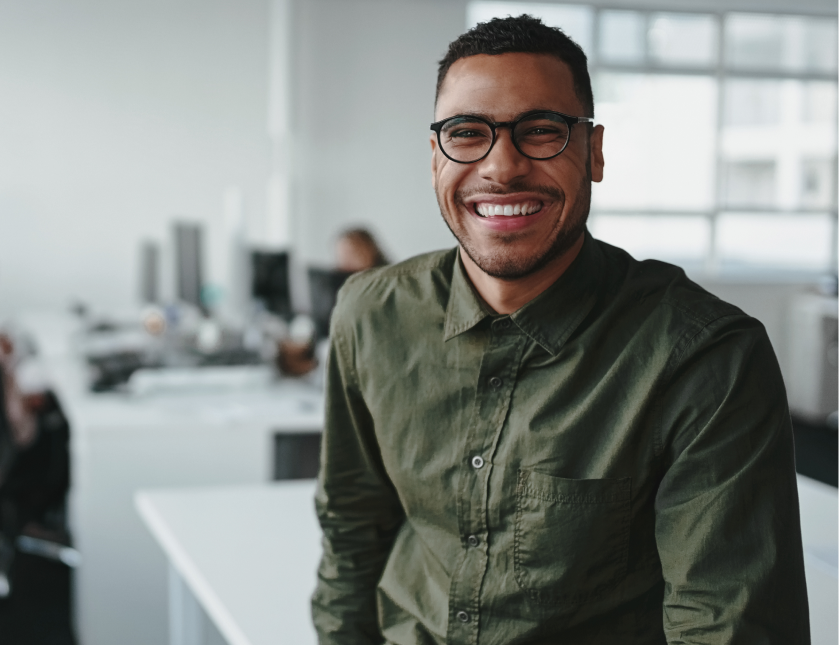 Person smiling in a modern office workspace